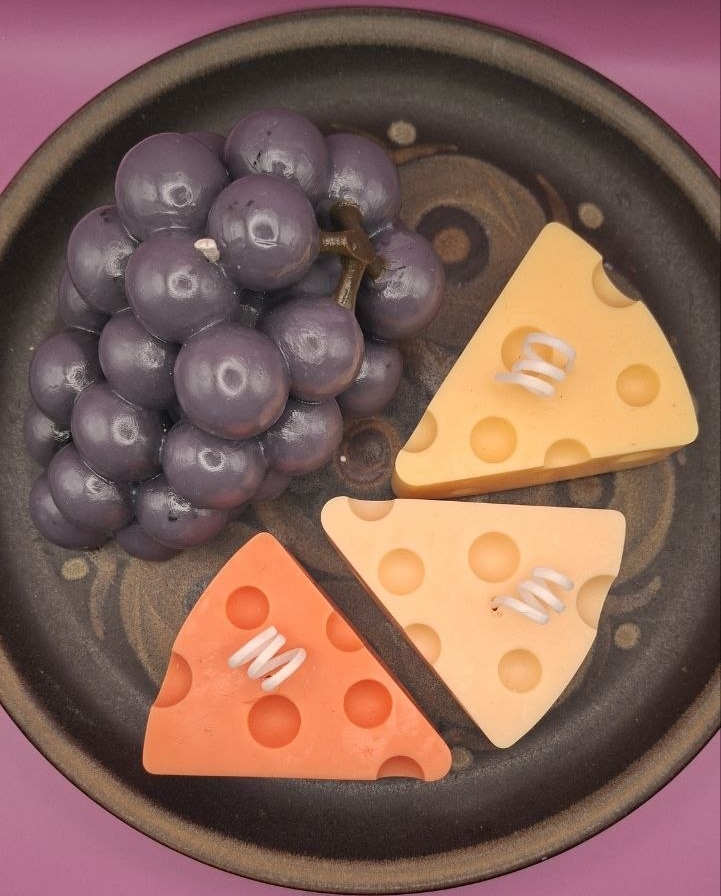 Candle Cheese and grapes on the plate up view