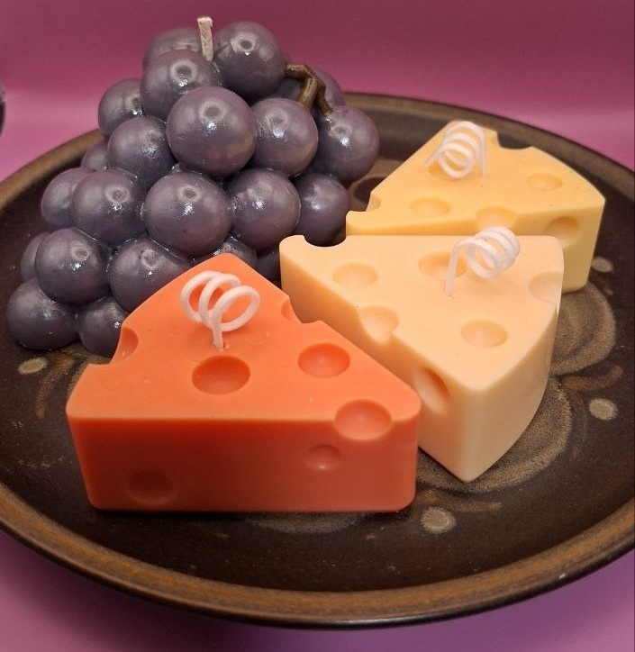 Candle Cheese and grapes on the plate